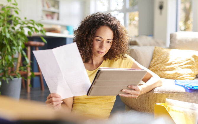 A woman is reading a guide to personal loans before deciding to take out a loan.