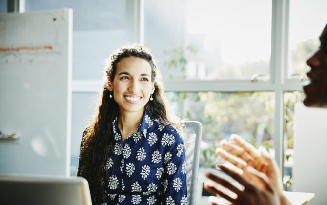 Smiling businesswoman learning how to pay off student loans