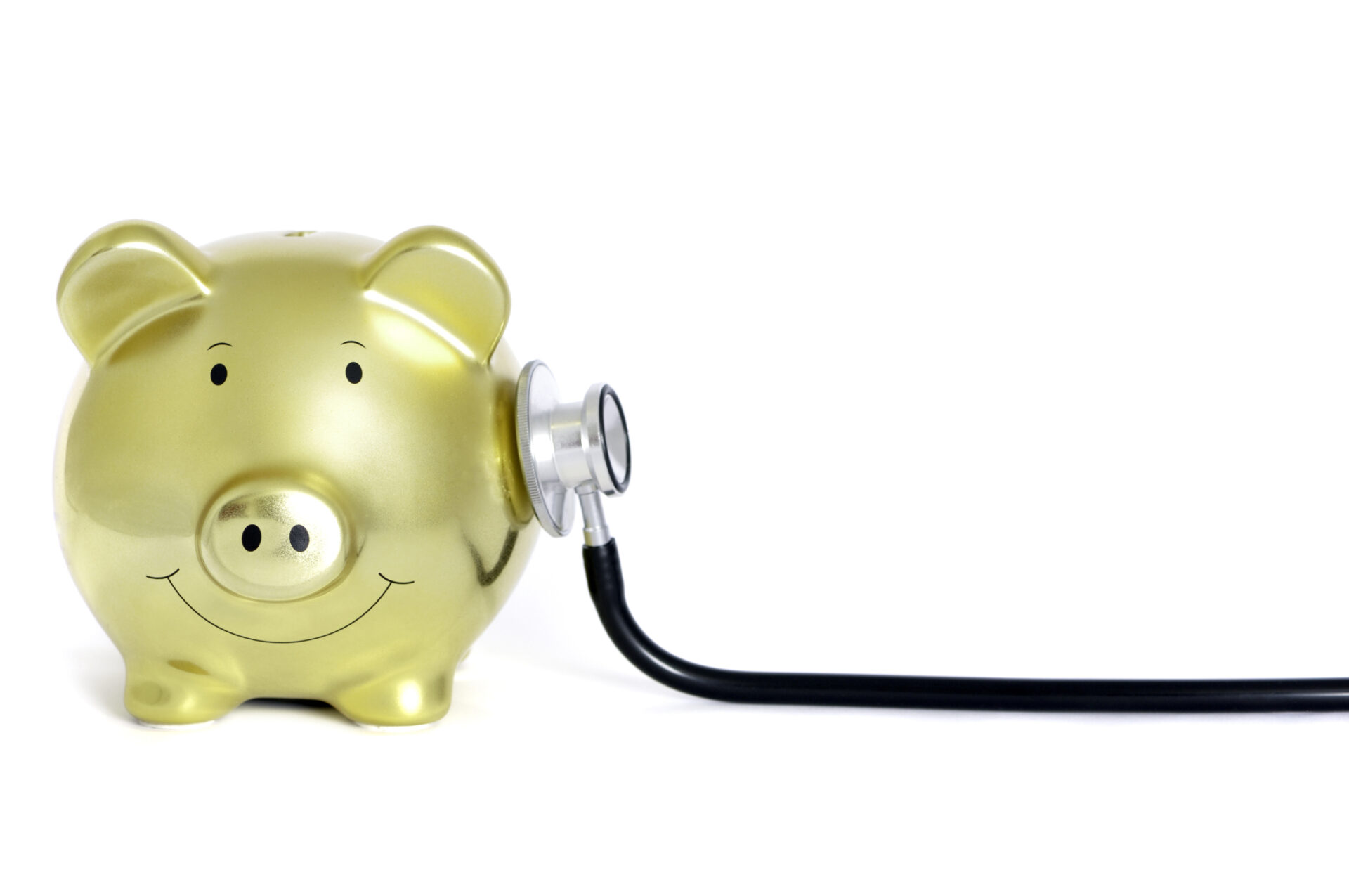 Yellow piggy bank with stethoscope on his side